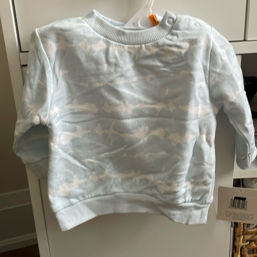 Indigo baby cloud design sweatshirt with snap buttons at the shoulder